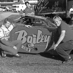 A black and white photo of Randy Sweet with Awesome Bill from Dawsonville at Kalamazoo Speedway in the 1980s.