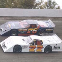 Terry Senneker Sr. and Randy Sweet drive racecars side-by-side at Winchester Speedway.