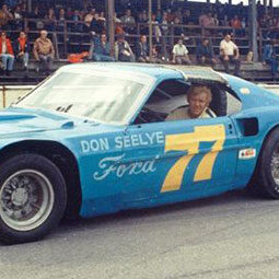 Randy Sweet sits in a Ford racecar on a track in the 1970s.