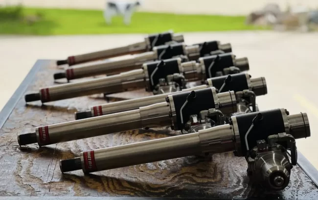 Race car parts from Sweet Manufacturing lined up on a table, ready for shipping to dealers and distributors.