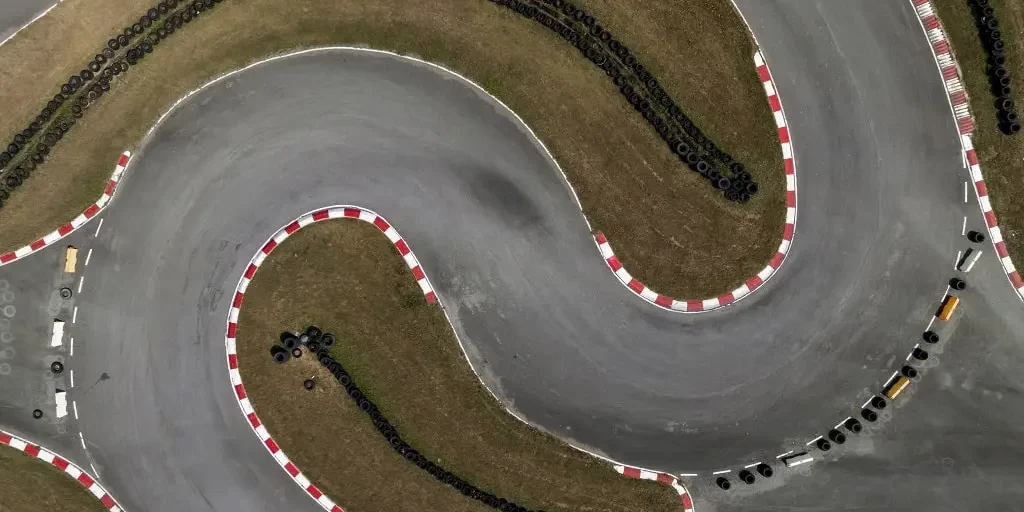 Aerial top view of a "S" curve set of turns on a race kart track for auto racing.
