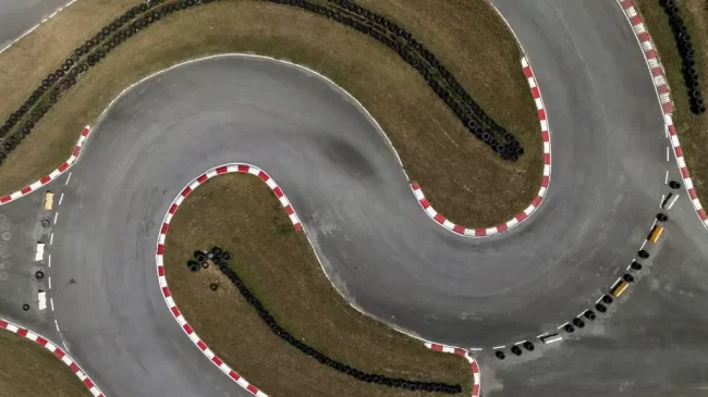 Aerial top view of a "S" curve set of turns on a race kart track for auto racing.