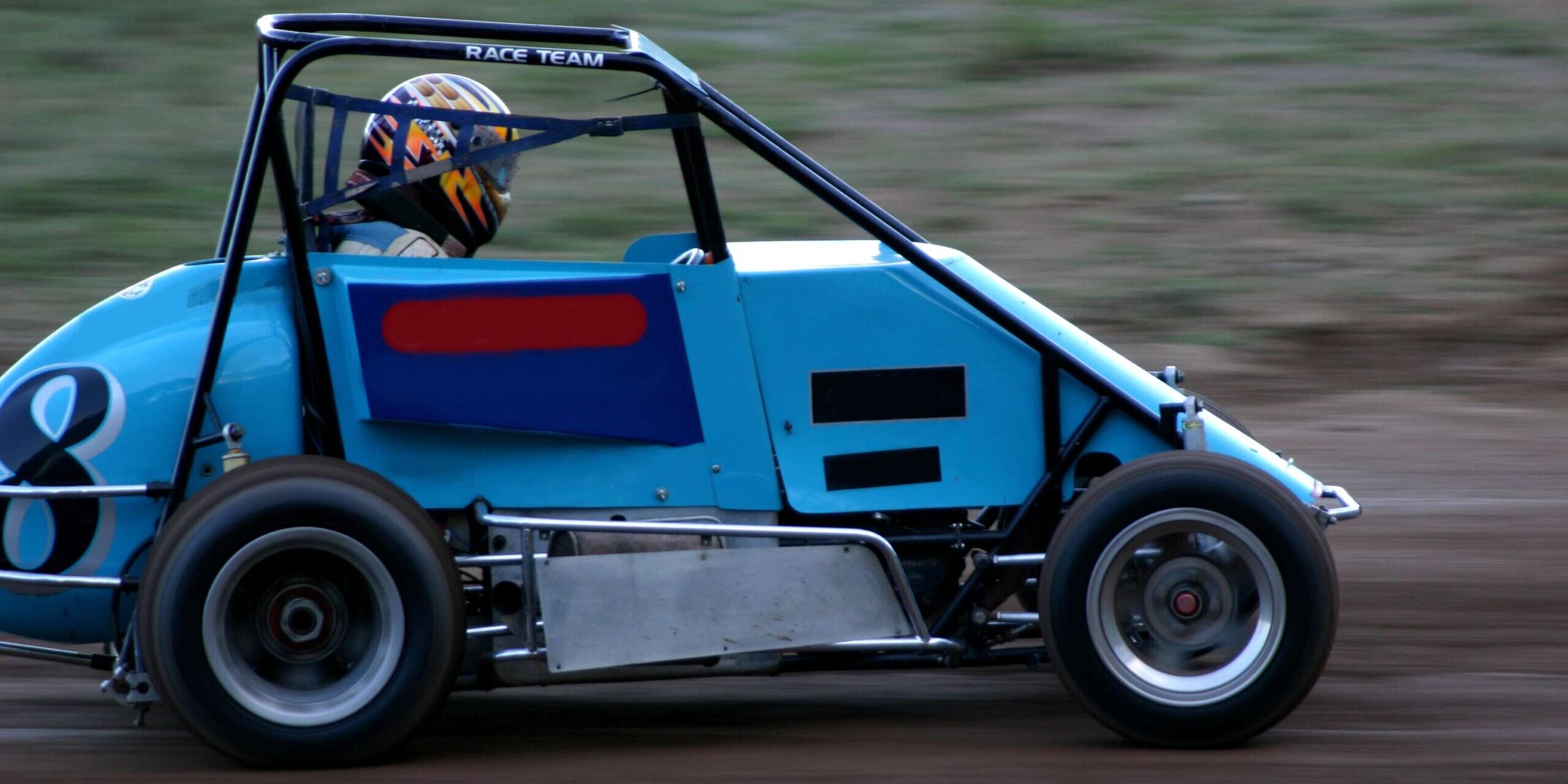 Sweet Manufacturing Sprint Car Racing Blog Photo 1 A blue race car drives down a dirt track.