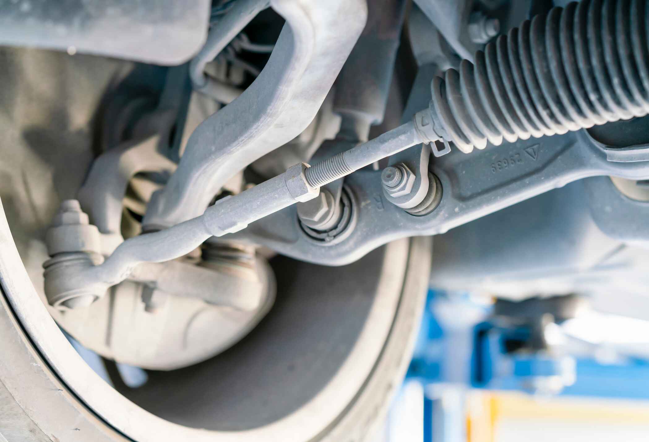 Image of the bottom of a car that has been lifted up for maintenance service.