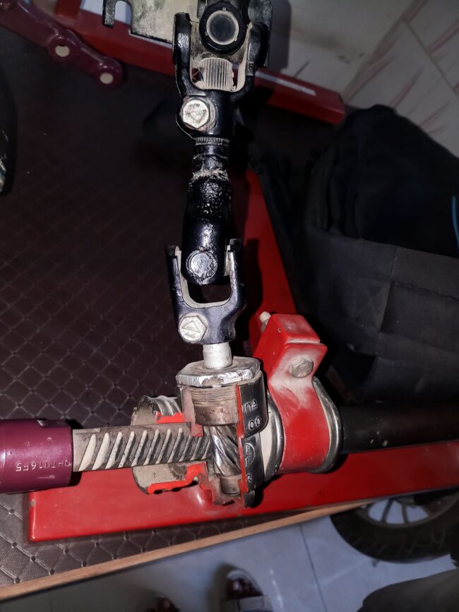 Steering mechanism Close-up of a rack and pinion steering mechanism.